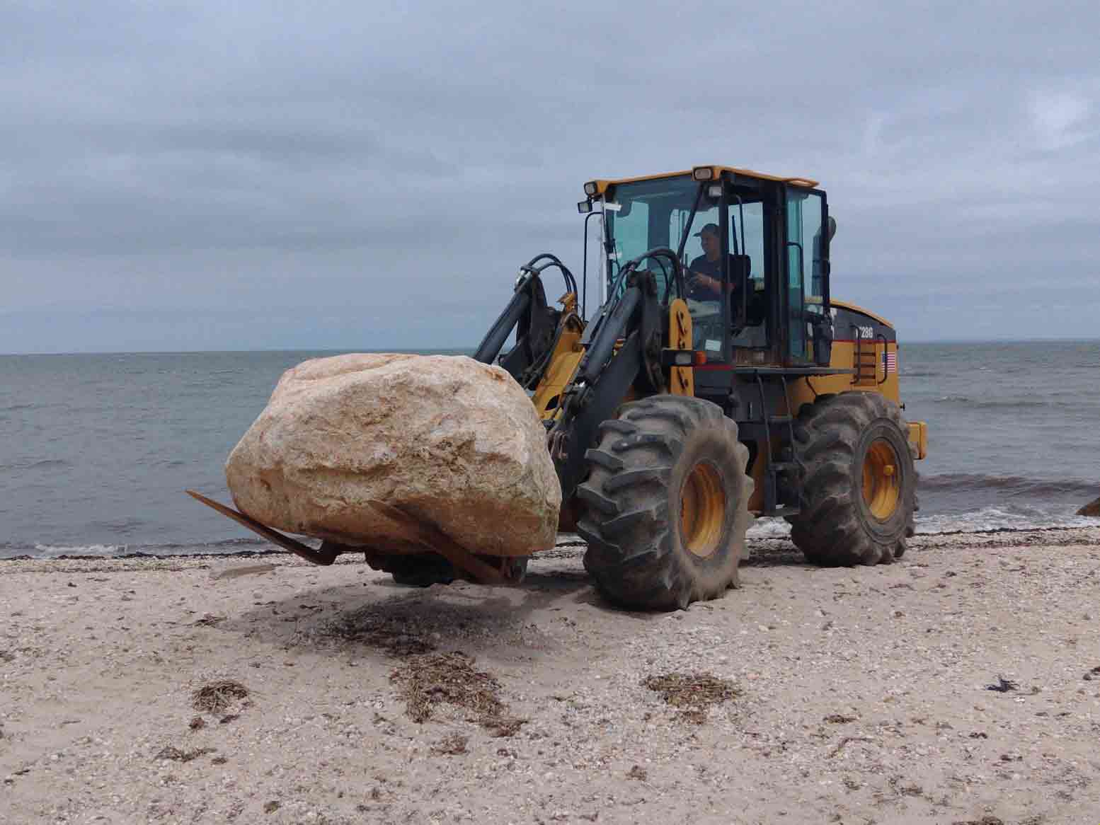 Excavator handling heavy stone